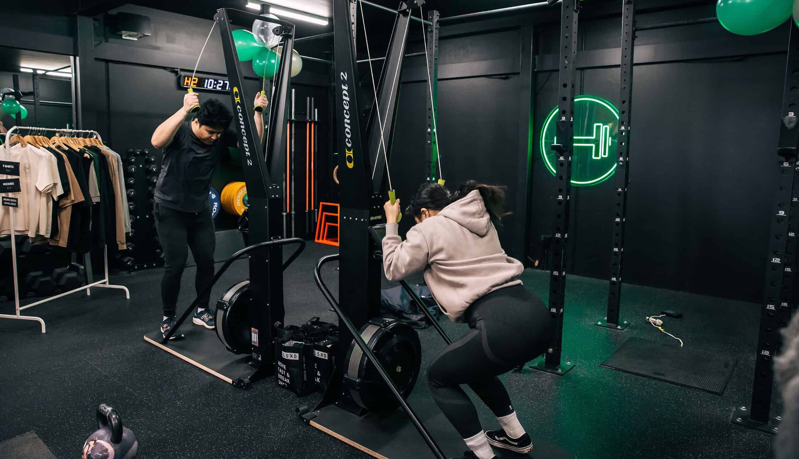 2 gym members using SkiErg machine at Habitat Gym in Prestons