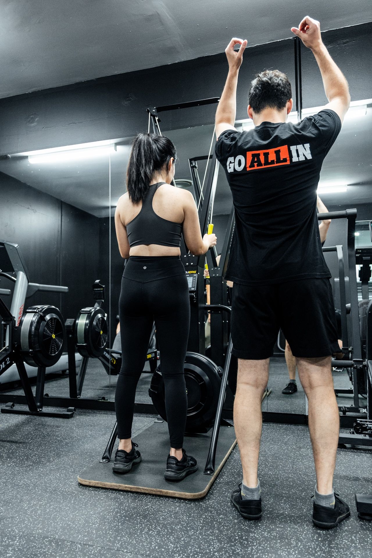Personal trainer coaching gym member on SkiErg cardio machine at Habitat Gym in Prestons