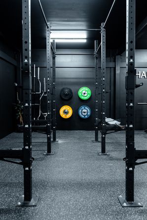 Exclusive private Prestons gym with bumper plates, barbells in clean modern training space