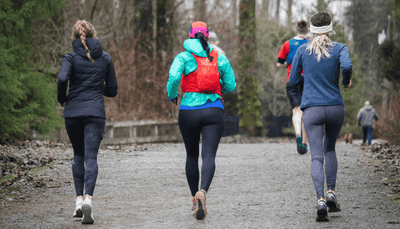 Group of people jogging outdoors during winter
