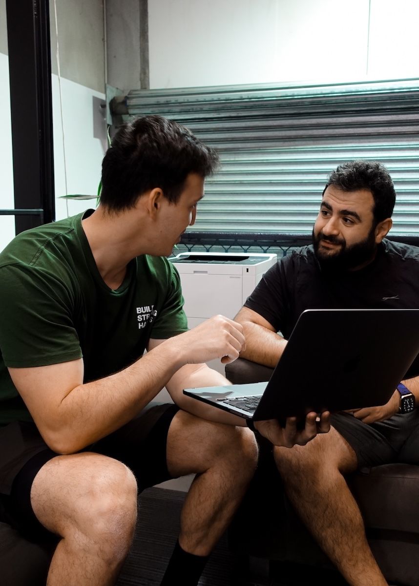 One-on-one coaching session at Habitat Gym, with a trainer discussing personalised nutrition and training plans with a member